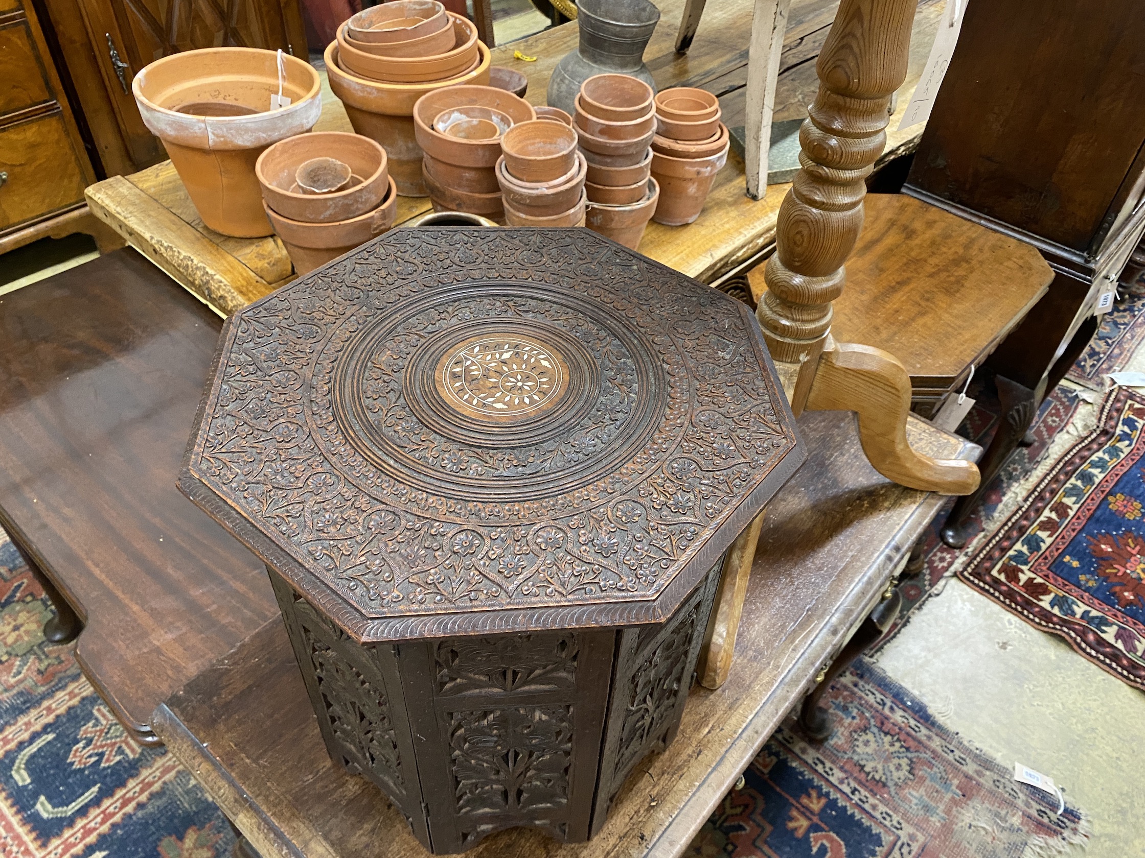 A Victorian style octagonal pine tripod wine table, width 47cm, height 72cm together with an Indian bone inlaid octagonal hardwood folding occasional table